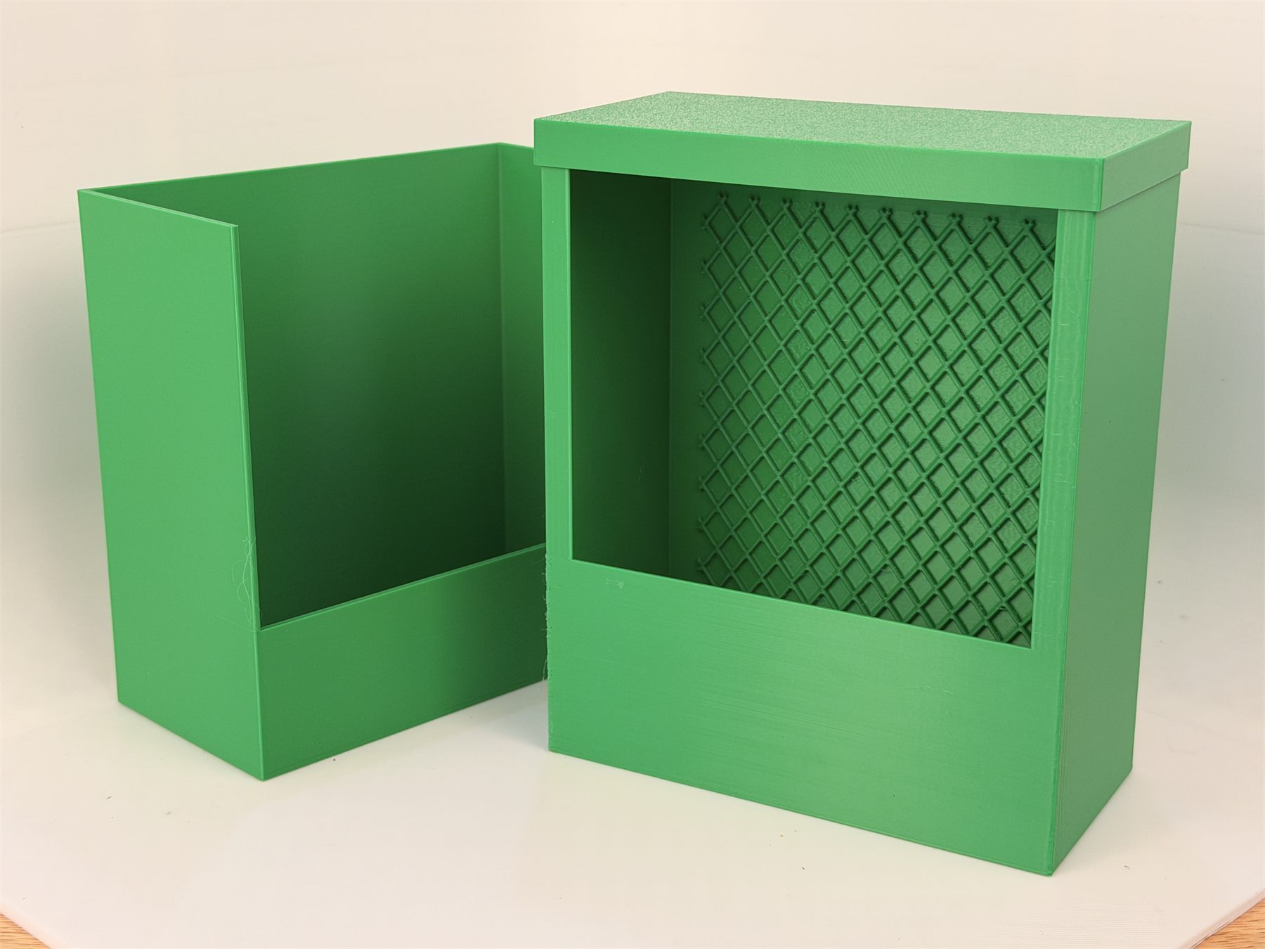 Green chameleon feeder system with the box separated from its wall mount